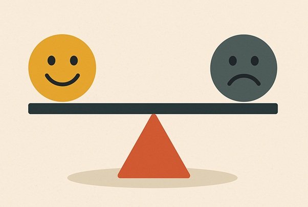 A seesaw with a smiling face on one side and a sad face on the other, representing the mix of easier and harder moments in daily life.