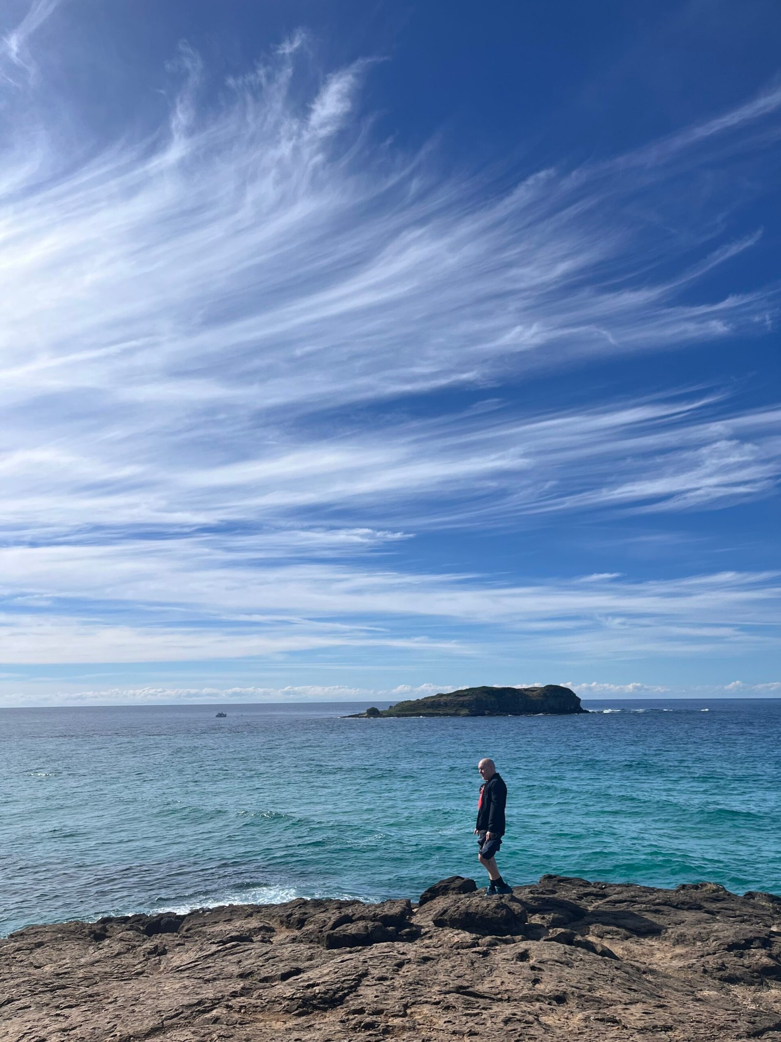 David Hennessy, Clinical Psychologist, reflecting calmly by the ocean, symbolising gentle and hopeful progress in overcoming selective mutism.