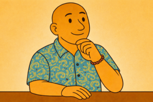 David Hennessy, Clinical Psychologist in Varsity Lakes, Gold Coast, sitting thoughtfully with hand on chin, wearing a blue paisley shirt and bead bracelet, reflecting on how personal narratives influence the nervous system